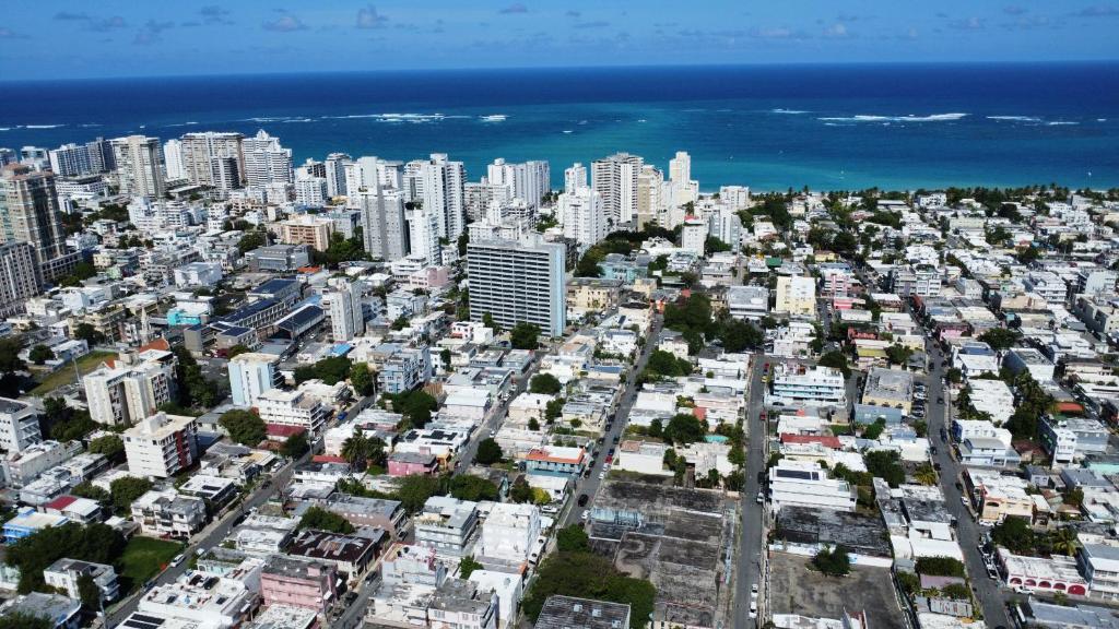 an aerial view of a city with buildings and the ocean at 176 Calle Perez (Apt 1A) in San Juan