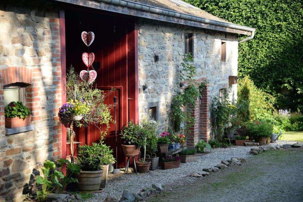 a building with a bunch of potted plants and balloons at La Renardière à Malmedy, près du circuit de Francorchamps in Malmedy