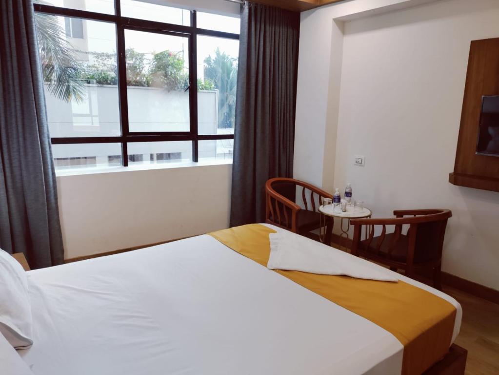 Postel nebo postele na pokoji v ubytování Astro Marine Hospitality Pvt Ltd