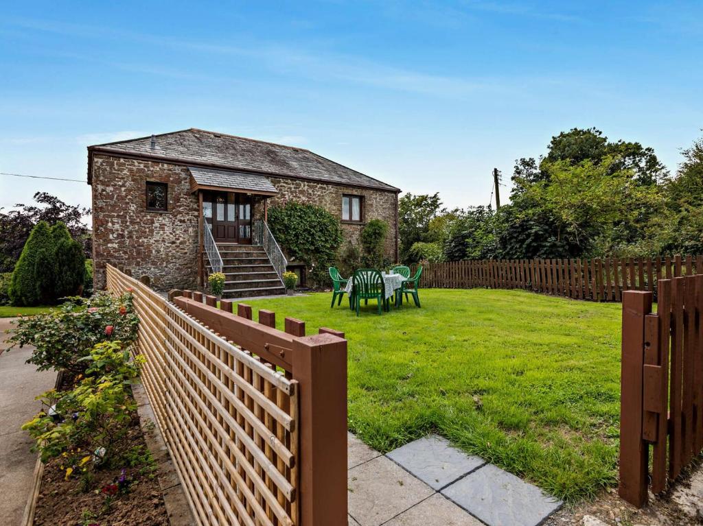 a fence in front of a house with a yard at 3 bed property in Bude SHEPH in Merryfield