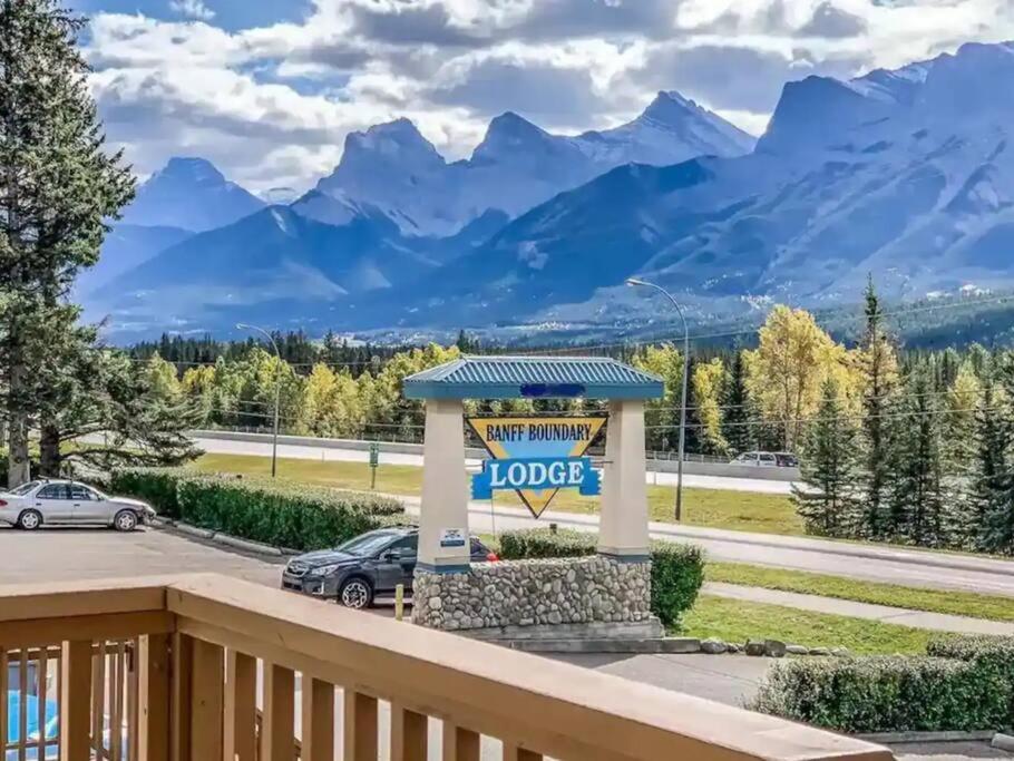 a sign on a porch with mountains in the background at B211 MTN View ground floor town house- 2BD, Sleeps 8, hot tub, free parking, close to Banff in Canmore