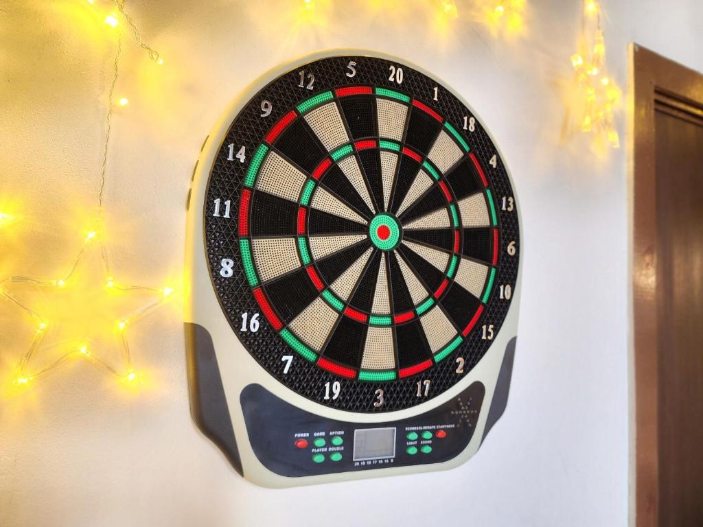 a dart board on a wall with christmas lights at Loft Suite Central City 2BR JB CIQ 7Pax in Johor Bahru