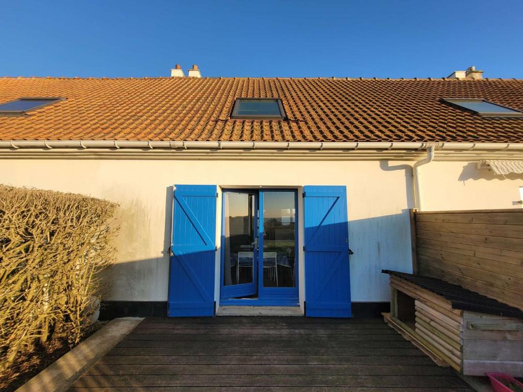 uma porta azul num edifício com telhado em Villa Ambleteuse, 3 pièces, 5 personnes - FR-1-675-35 em Ambleteuse