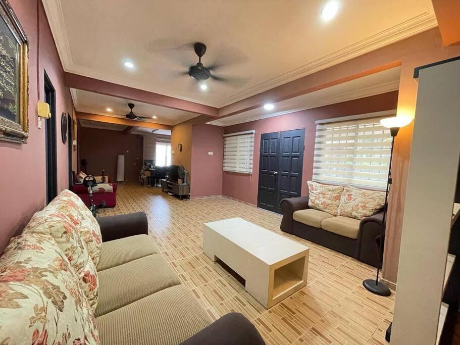 a living room with a couch and a table at MP Homestay Lost world of tambun in Kampong Batu Lapan