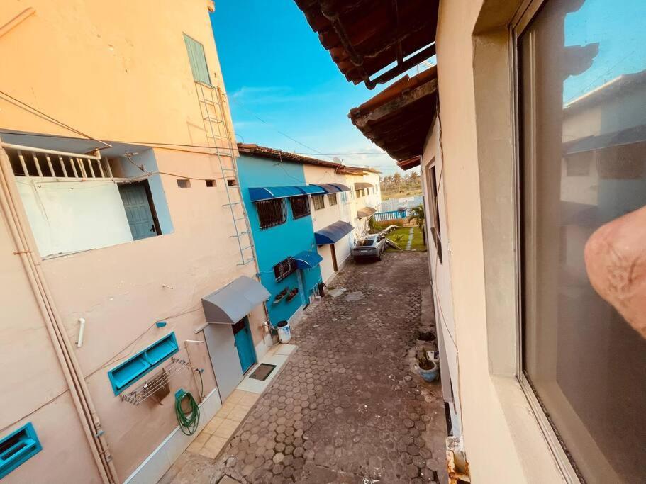 a view from a window of an alley between buildings at Duplex em condomínio / Guriri ES in São Mateus