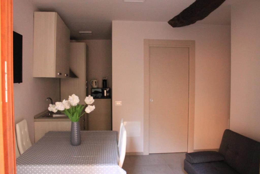 a room with a table with a vase of flowers on it at La Ponzianina in Spoleto