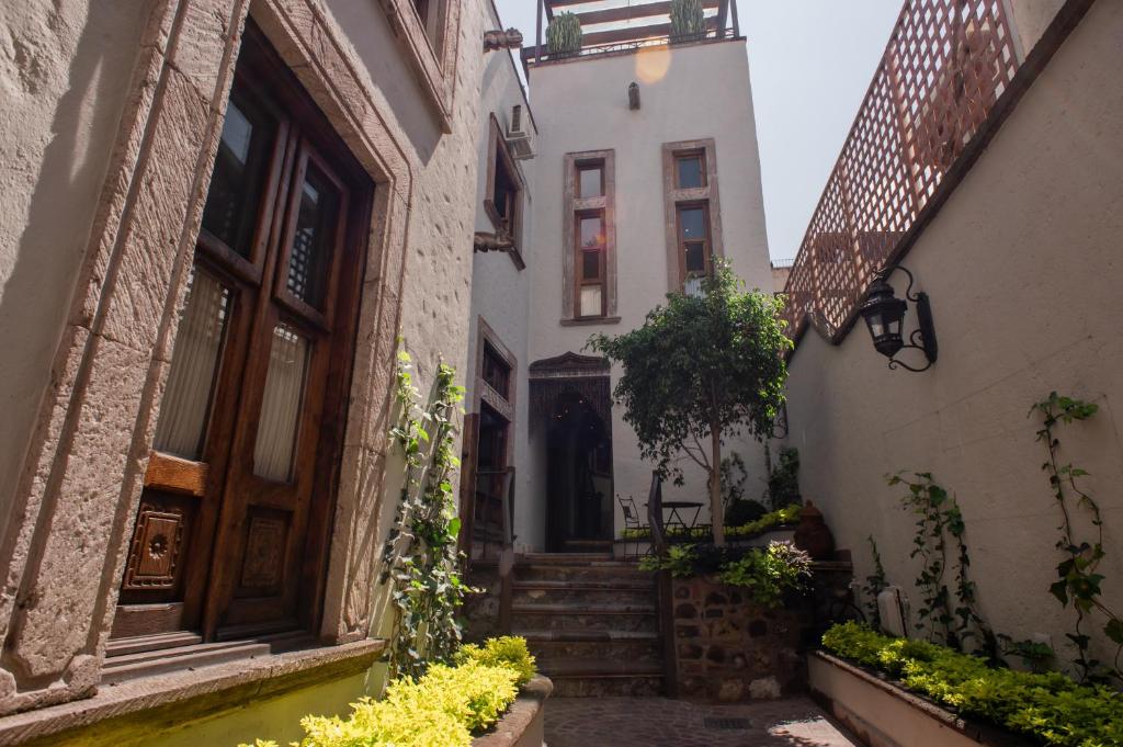 an alleyway in an old town with buildings at Sollano 34 in San Miguel de Allende