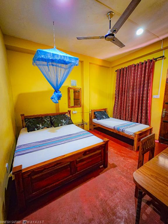 Postel nebo postele na pokoji v ubytování Dinesh Safari Homestay