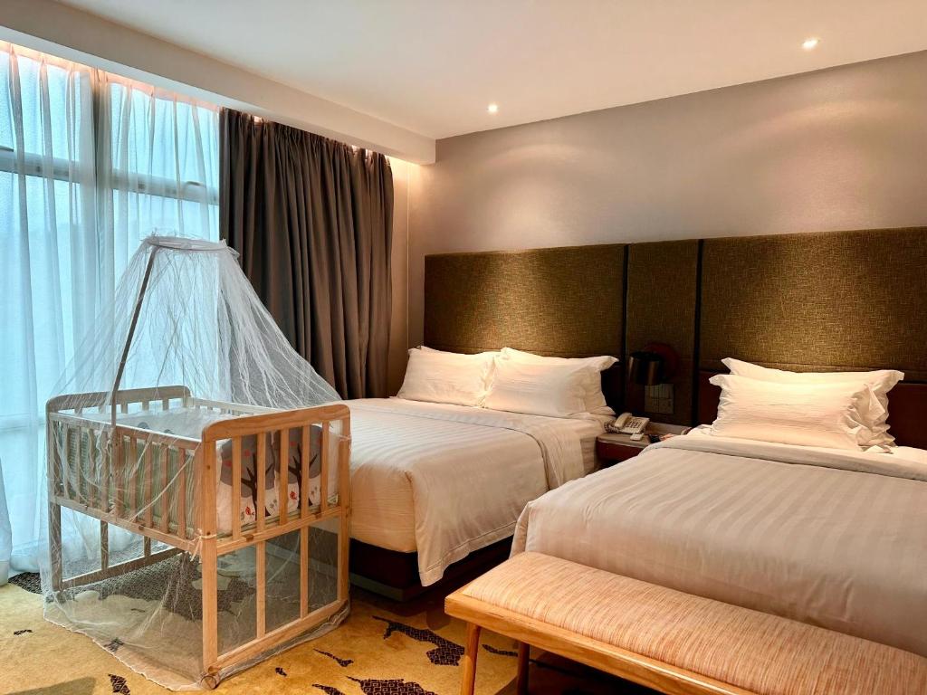 Postel nebo postele na pokoji v ubytování King Park Hotel Kota Kinabalu