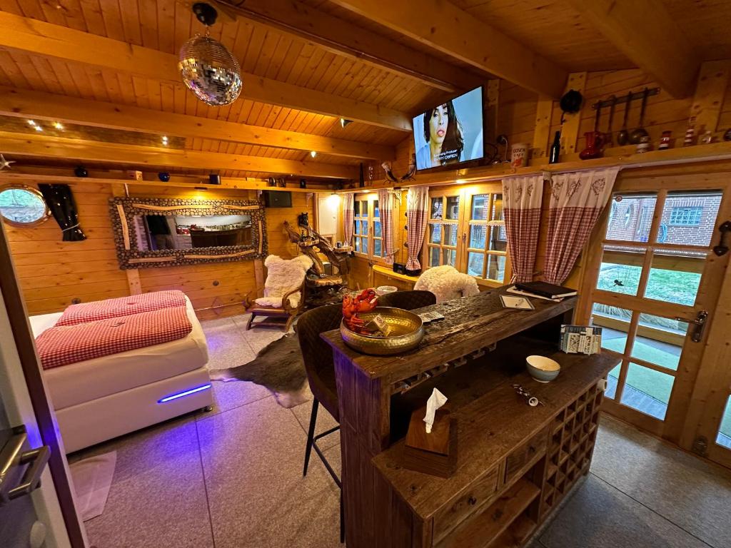 a living room with a couch and a tv in a cabin at ELB - HUS - Elbe 1 in Neufeld