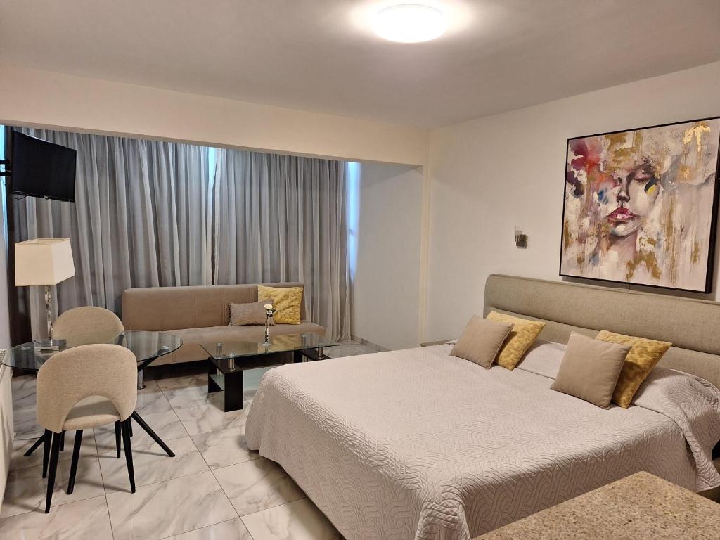 A bed or beds in a room at Marianna Hotel Apartments