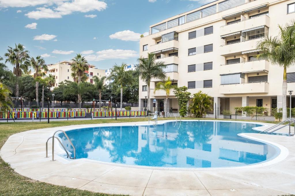 a swimming pool in front of a building at Playamarinsa in Torre del Mar