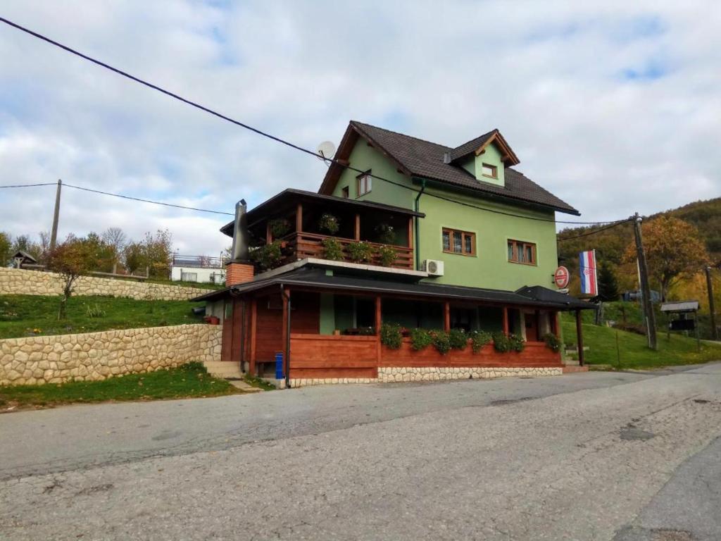 a house on the side of a road at Apartments Poljanak Green House in Plitvička Jezera