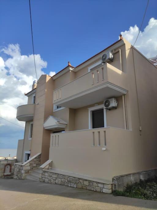 a building with a white fence in front of it at Varkaris Room 1 in Katarráktis