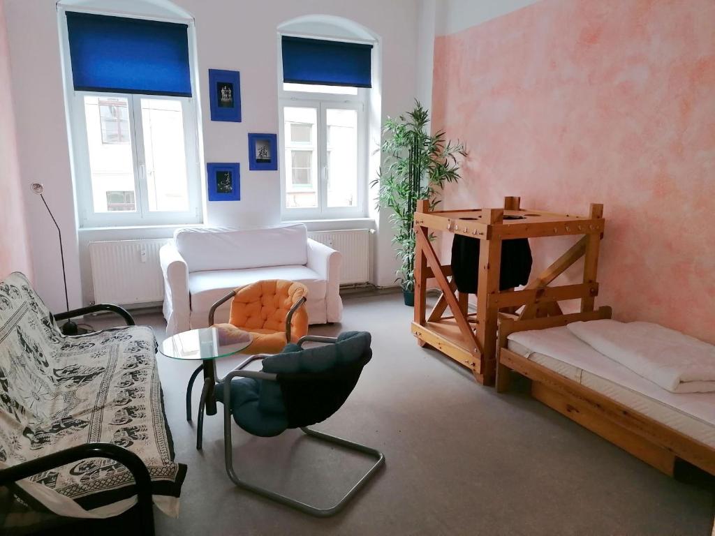 a living room with chairs and a couch and a table at Kulturschutzgebiet in Dresden