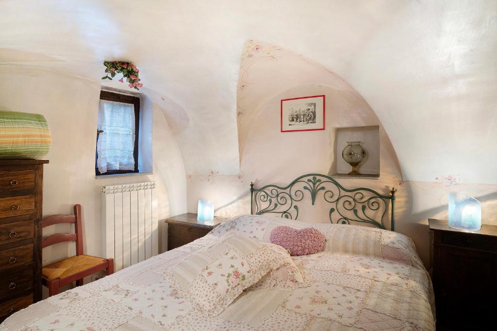 a bedroom with a bed with a fancy headboard at Appartamento dei Fiori in Apricale