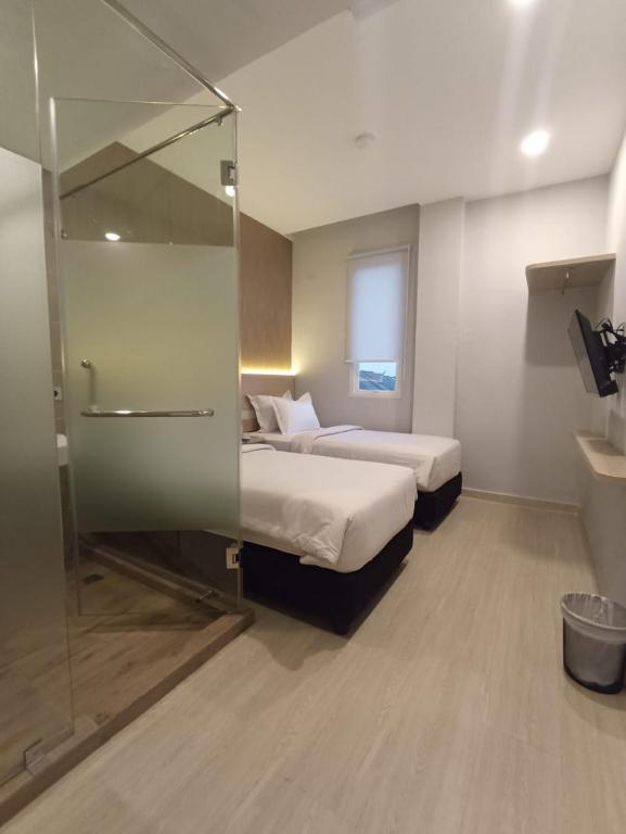 Postel nebo postele na pokoji v ubytování Swasana Hotel Medan