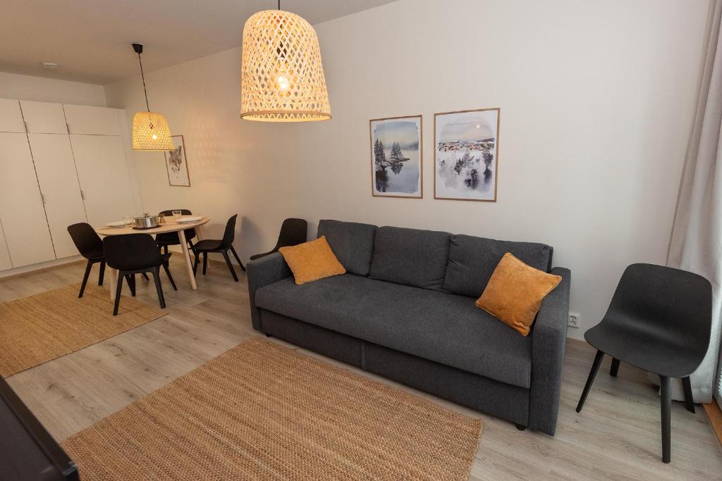 a living room with a couch and a table at Holiday Apartment Aava 2 in Rovaniemi