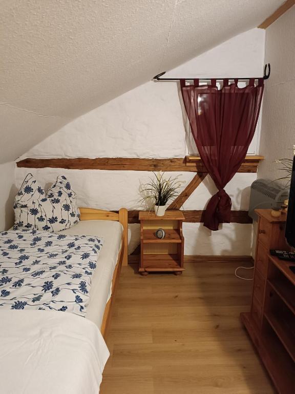 1 dormitorio con 1 cama y 1 mesa con ventana en Erlebnisreiterhof Wolferstadt, 