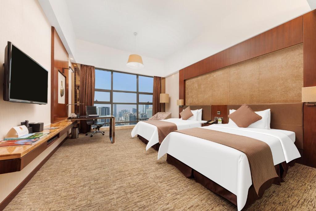 Postel nebo postele na pokoji v ubytování Vanburgh Hotel - Free shuttle bus transfer during Canton Fair