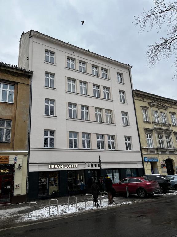 a large white building on the side of a street at High Standard Room in Jewish District, Apartment Shared with Host in Krakow