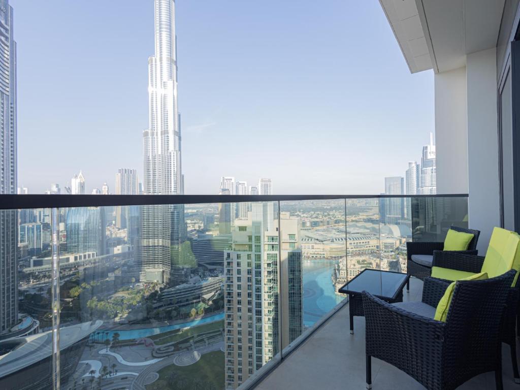 a balcony with chairs and a view of a city at MH- Act - Burj View 3BHK-REF4008 in Dubai