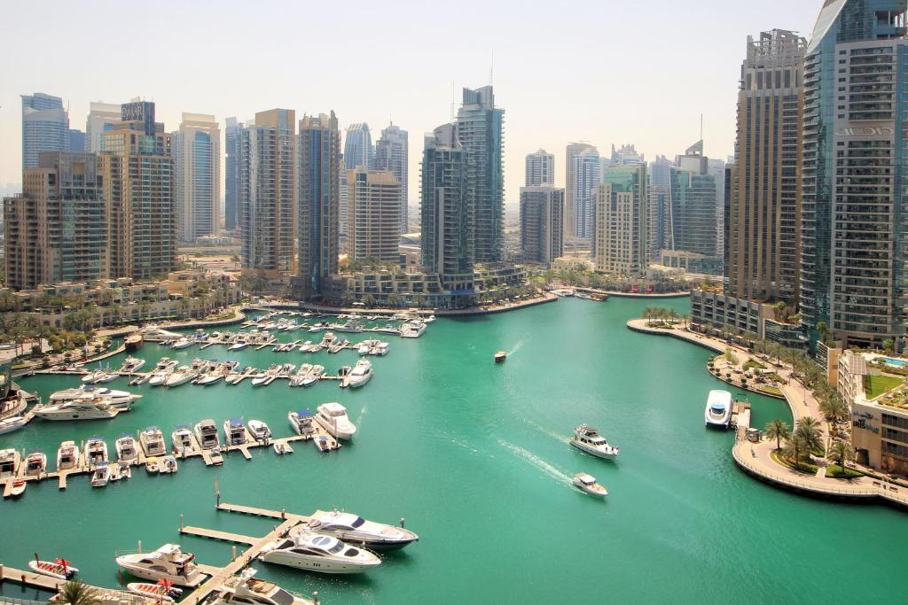 an aerial view of a harbor with boats in a city at Panoramic Marina View 2BR Suite Damac Heights in Dubai
