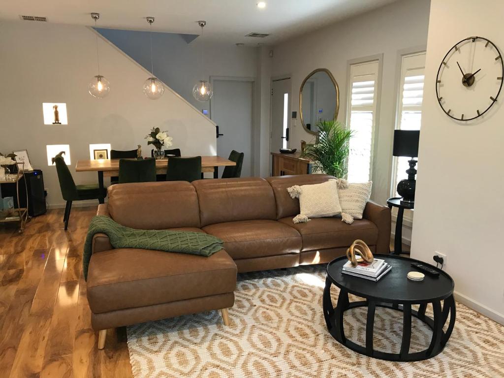 a living room with a couch and a table at Casa Piscina - Our Pool House in South Plympton