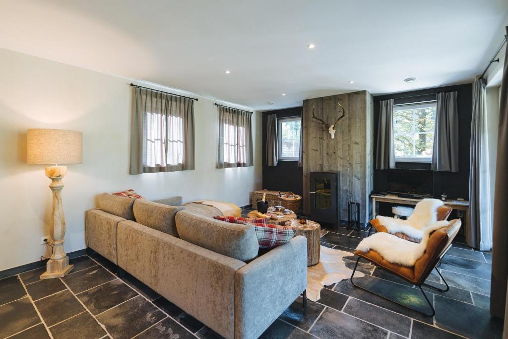 a living room with a couch and a table at Le Brocard in Durbuy