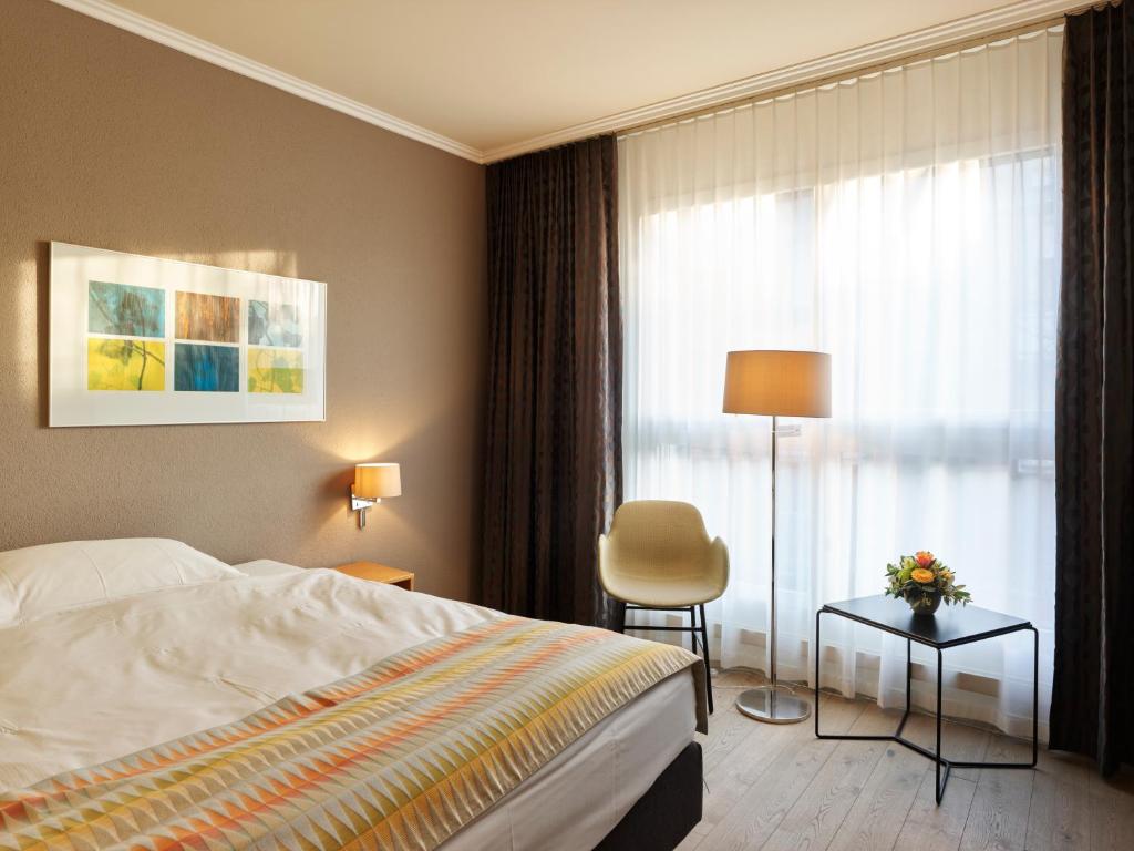 Postel nebo postele na pokoji v ubytování Hotel Berchtold