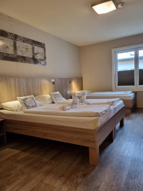 a bedroom with two large beds in a room at Cubo Sport & Art Hotel in Sankt Johann in Tirol