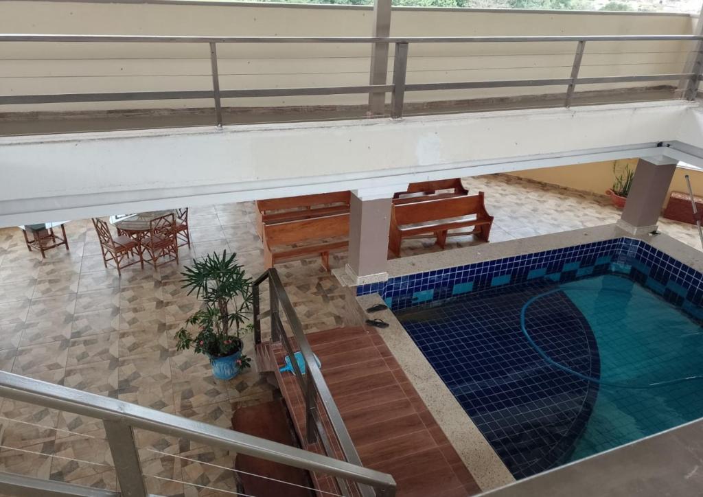 an overhead view of a swimming pool in a building at Hotel Avenida in Pardinho