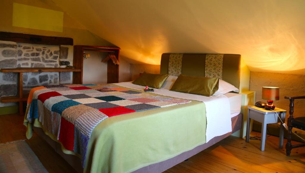 a bedroom with a large bed in a room at Les Grandes Fontaines in La Longine