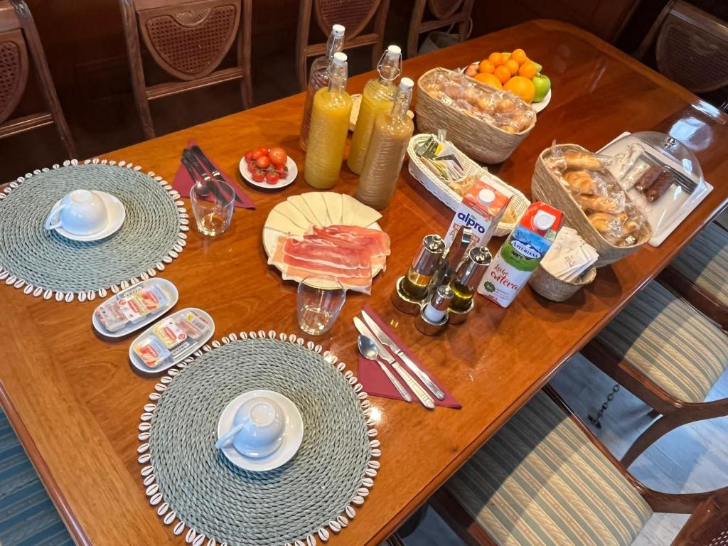 a wooden table with plates of food on it at Southern Cross in Barcelona