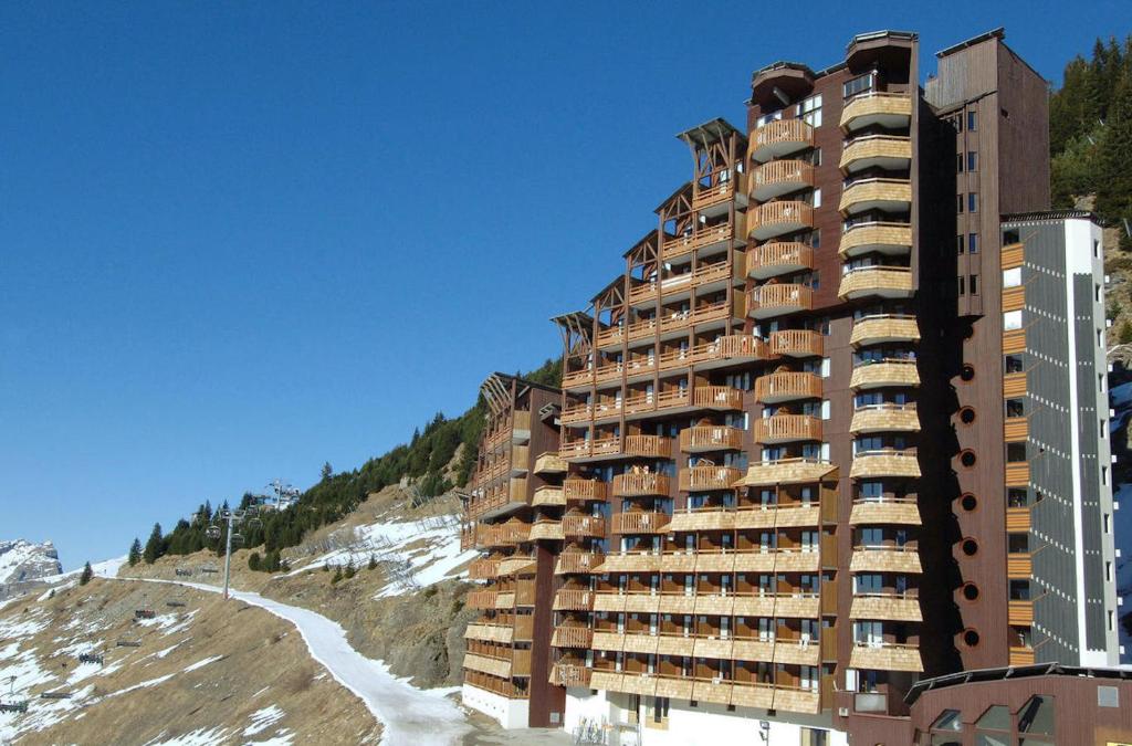 a tall building on a hill next to a river at Résidence Antarès - Avoriaz in Avoriaz