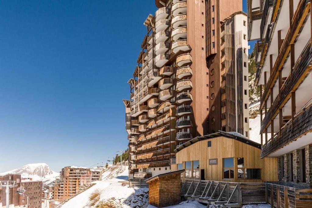 a tall building with snow on the ground at Résidence Antarès - Avoriaz in Avoriaz