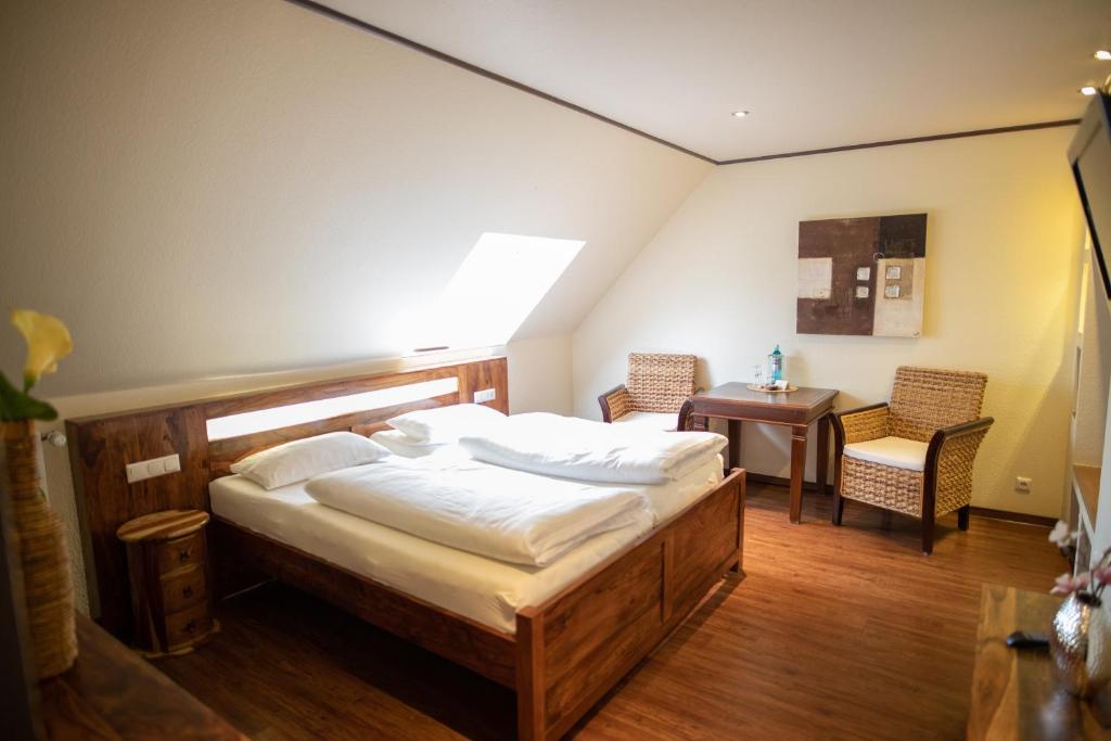 una camera con letto, tavolo e sedie di Vier Jahreszeiten Rooms a Husum
