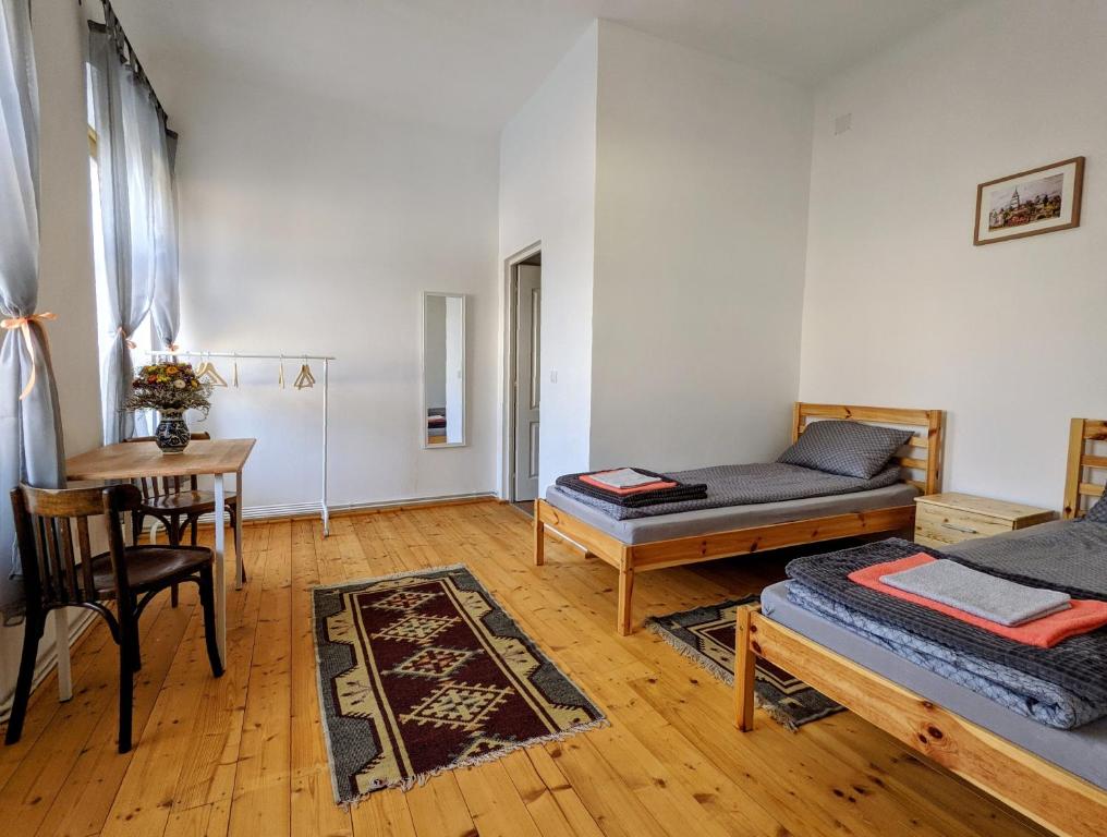a living room with two beds and a table at Gästehaus Honigberg next to the Fortified Church of Harman in Hărman
