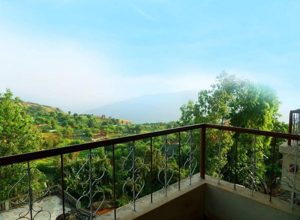 a balcony with a view of a valley at The Forest World in Mahabaleshwar