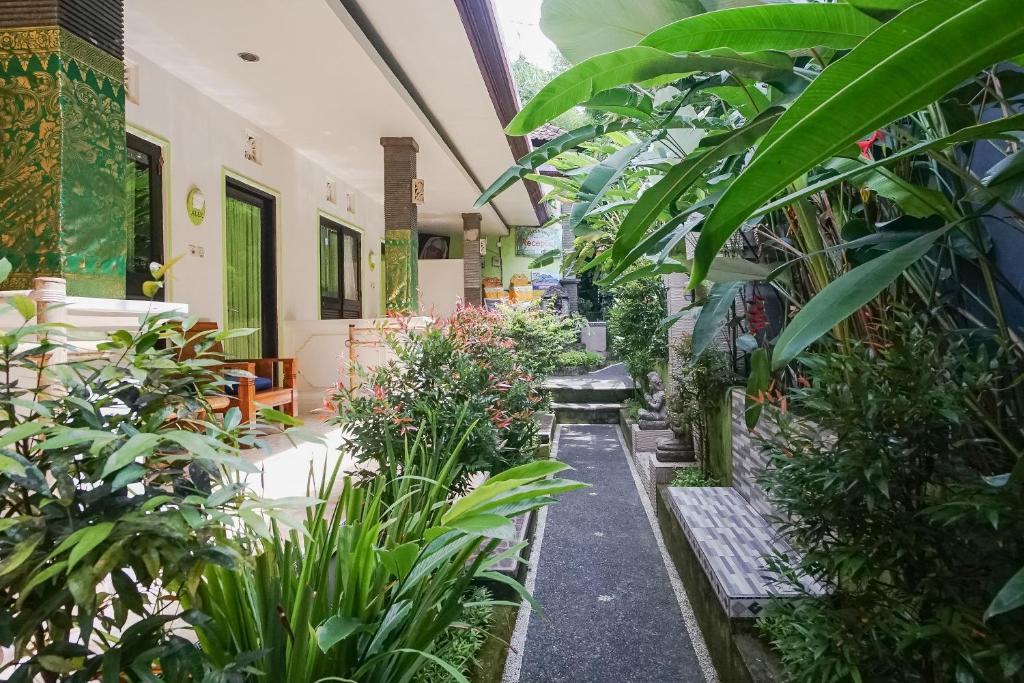 a garden with plants and a bench in a building at Green View Ubud Hostel Bali in Ubud
