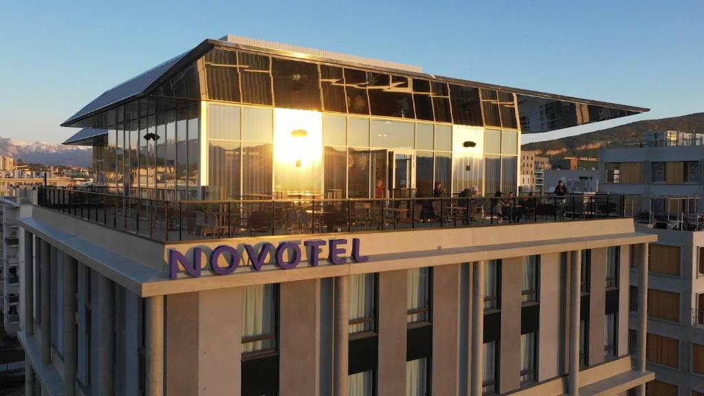 a building with a sign on the top of it at Novotel Annemasse Centre - Porte de Genève in Annemasse