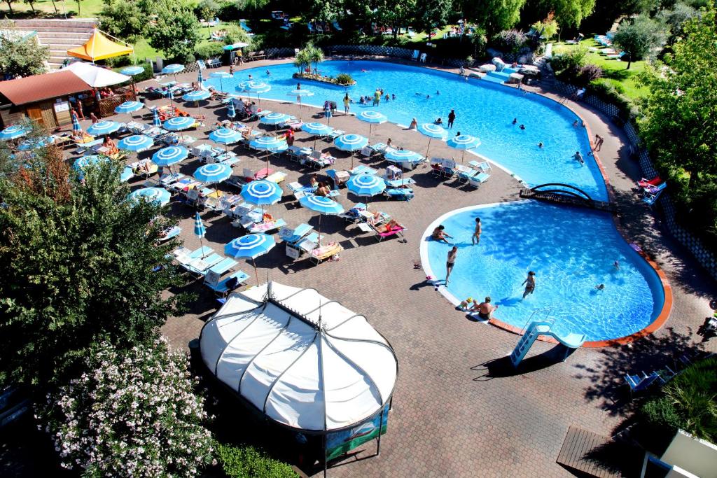 an overhead view of a swimming pool with blue and white umbrellas at Centro Vacanze San Marino in San Marino