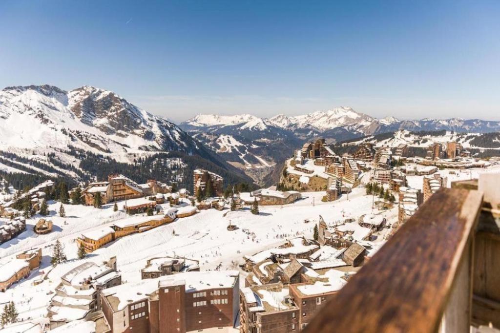 a city covered in snow with mountains in the background at Résidence Antarès - Avoriaz in Avoriaz