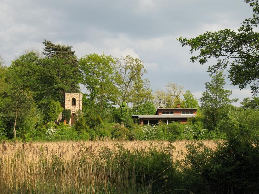 ein Haus und ein Gebäude mitten auf einem Feld in der Unterkunft Ferienwohnung Erlkron in Schiedenhohlweg