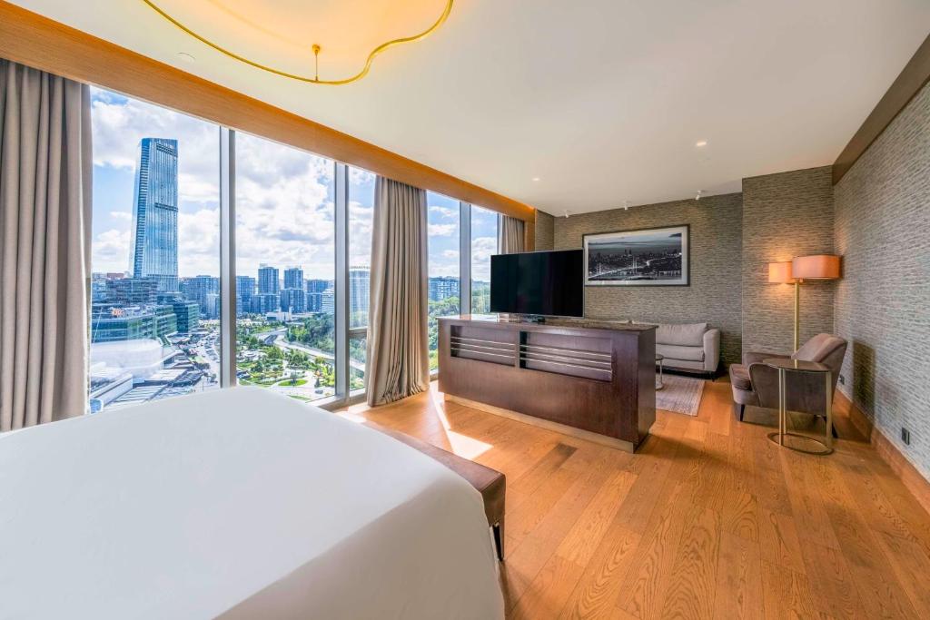 a hotel room with a bed and a large window at Radisson Collection Hotel, Vadistanbul in Istanbul