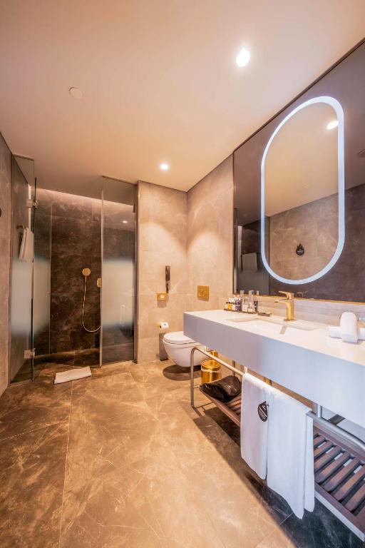 a bathroom with a sink and a shower at Radisson Collection Hotel, Vadistanbul in Istanbul