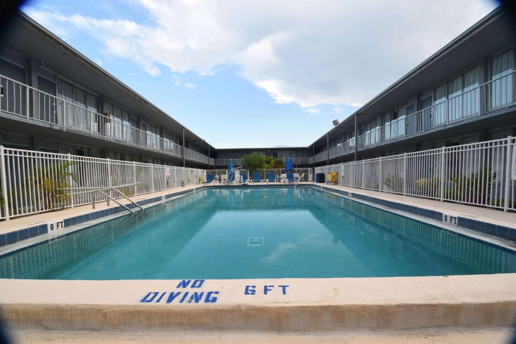 a large swimming pool in front of a building at Days Inn by Wyndham Stuart in Stuart