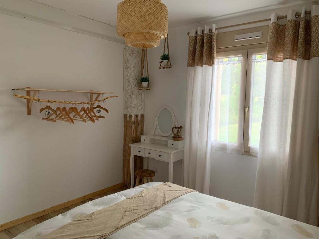 a bedroom with a bed and a sink and a mirror at Gite de Groupe Aux Instants Partagés in Fontenay-sur-Vègre