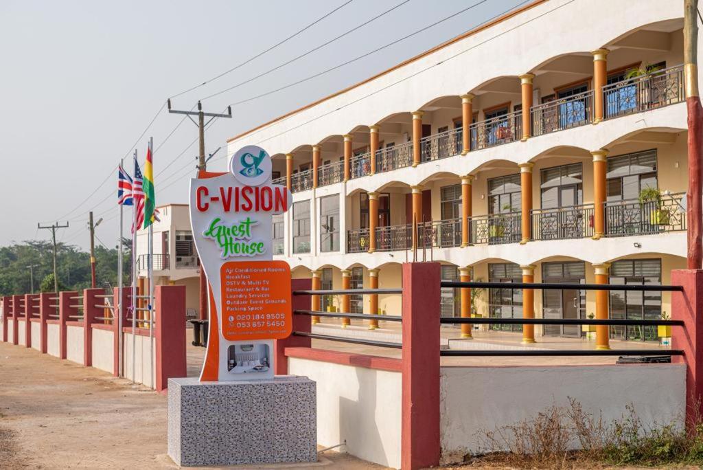 a building with a sign in front of it at C-VISION GUESTHOUSE 