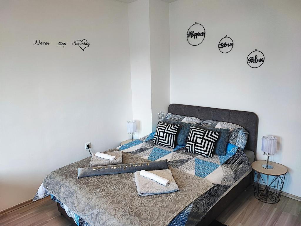 a bedroom with a bed with pillows on it at Apartman Luxe Victoria in Zagreb